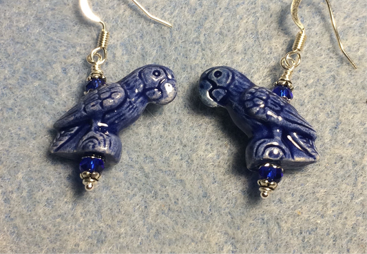 Dark blue ceramic parrot bead earrings adorned with dark blue Chinese crystal beads.