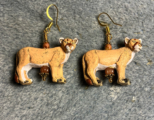 Orange tan ceramic mountain lion bead earrings adorned with orange Czech glass beads.