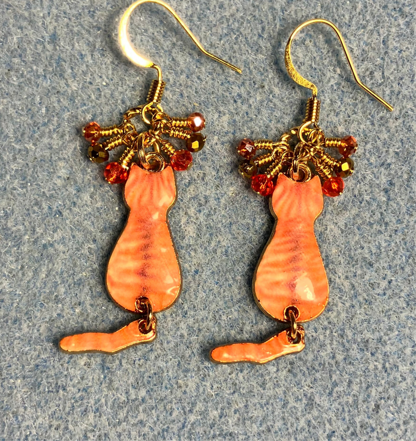 Orange and gold enamel tabby cat charm earrings adorned with tiny dangling orange and gold Chinese crystal beads.