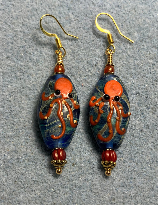 Blue and orange lamp work octopus bead earrings adorned with orange Czech glass beads.