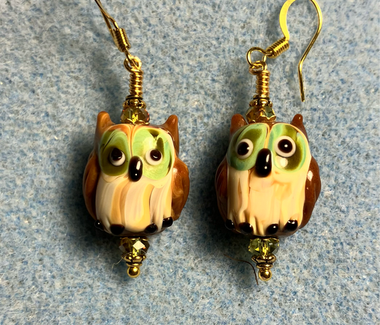 Brown and green lamp work owl bead earrings adorned with sparkly green Chinese crystal beads.
