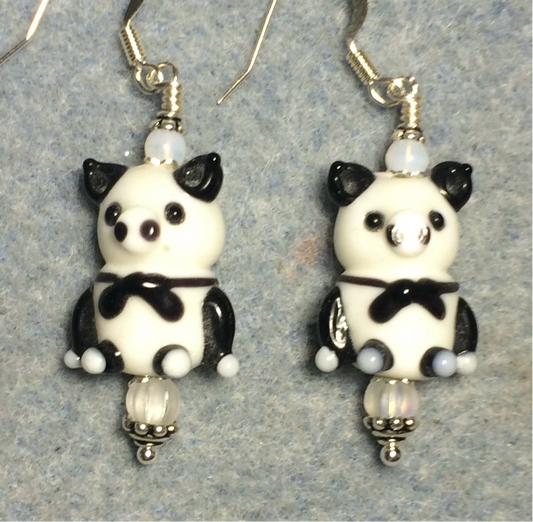 White and black tuxedo clad lamp work pig bead earrings adorned with milky white Czech glass beads.