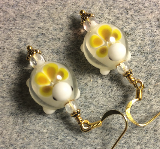 Clear and yellow lamp work turtle bead earrings adorned with clear Czech glass beads.