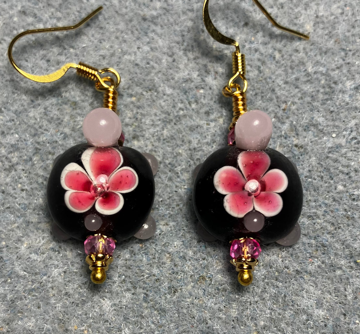 Dark red and pink lamp work turtle bead earrings adorned with hot pink Chinese crystal beads.
