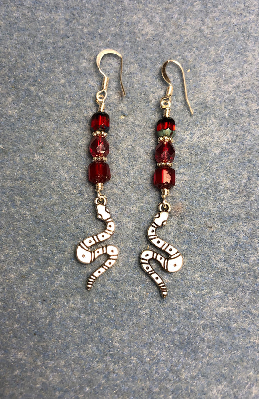 Silver coiled snake charm earrings adorned with red Czech glass beads