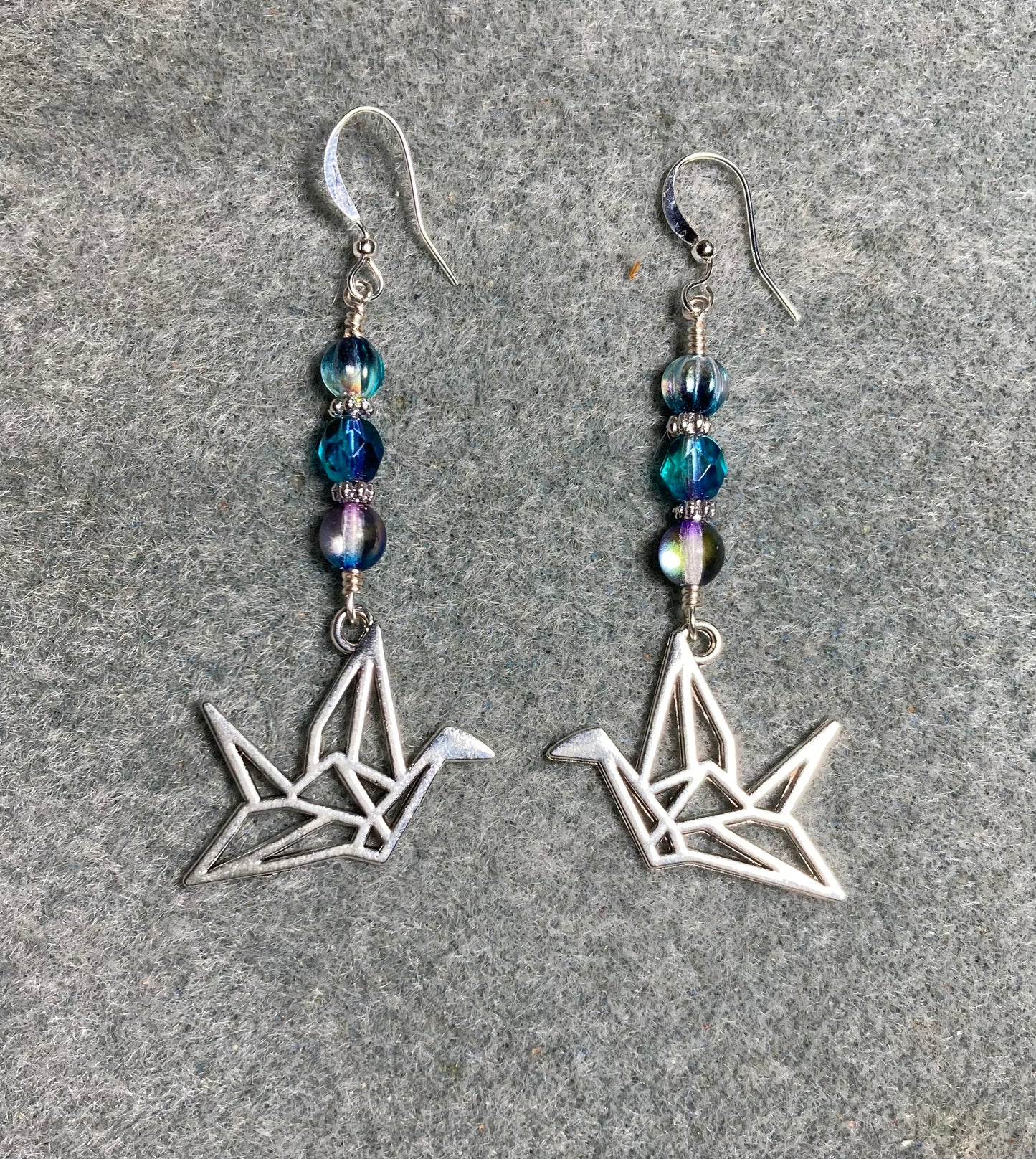 Silver origami crane charm earrings adorned with blue purple Czech glass beads