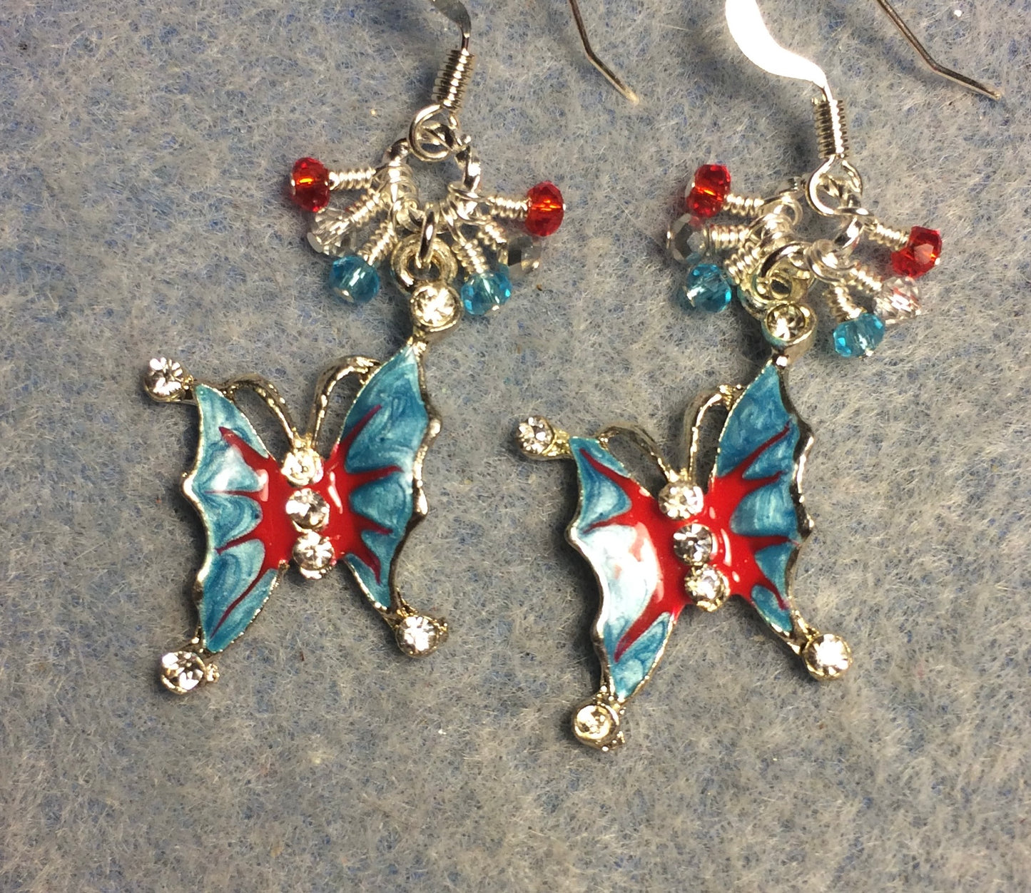 Turquoise, silver, and red enamel and rhinestone butterfly charm earrings adorned with tiny dangling turquoise, silver, and red Chinese crystal beads.