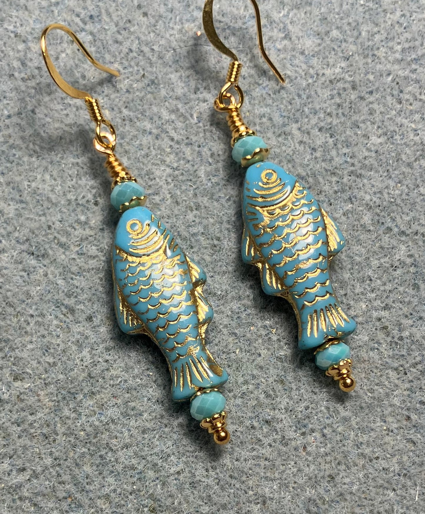 Light turquoise (with gold inlay) Czech glass fish bead earrings adorned with turquoise Chinese crystal beads.