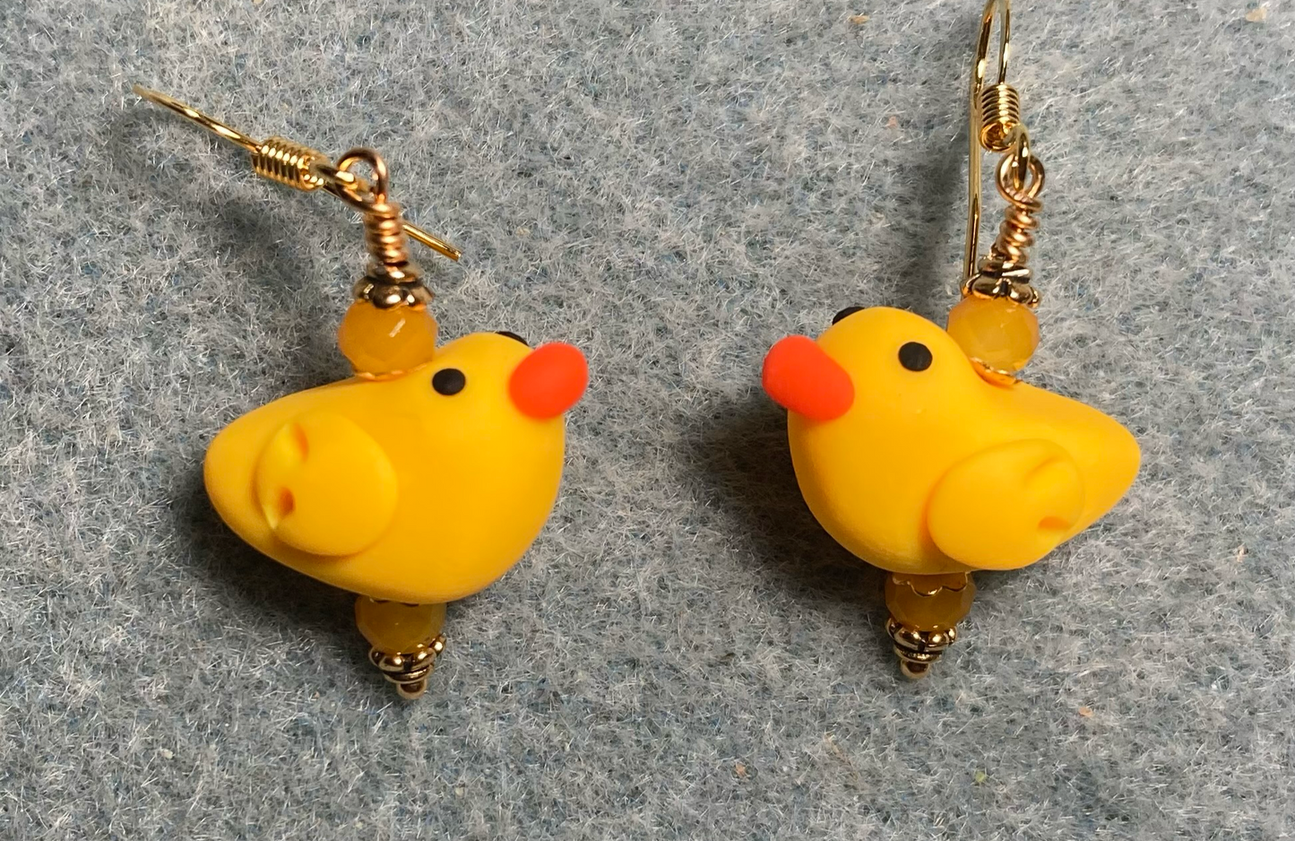Golden yellow and orange polymer clay duck bead earrings adorned with golden yellow Chinese crystal beads.