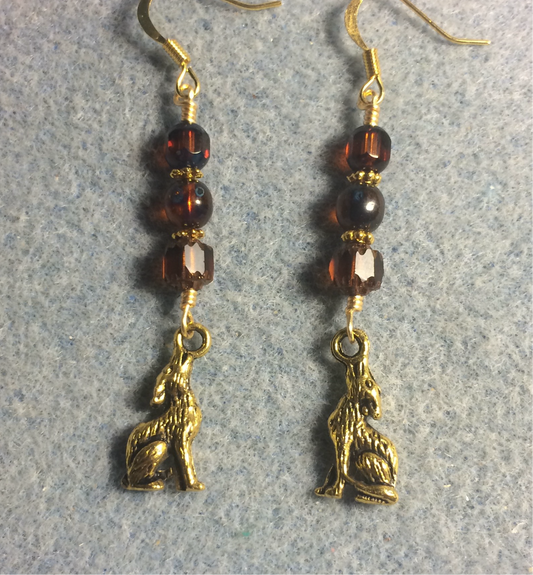 Gold howling coyote charm earrings adorned with brown Czech glass beads