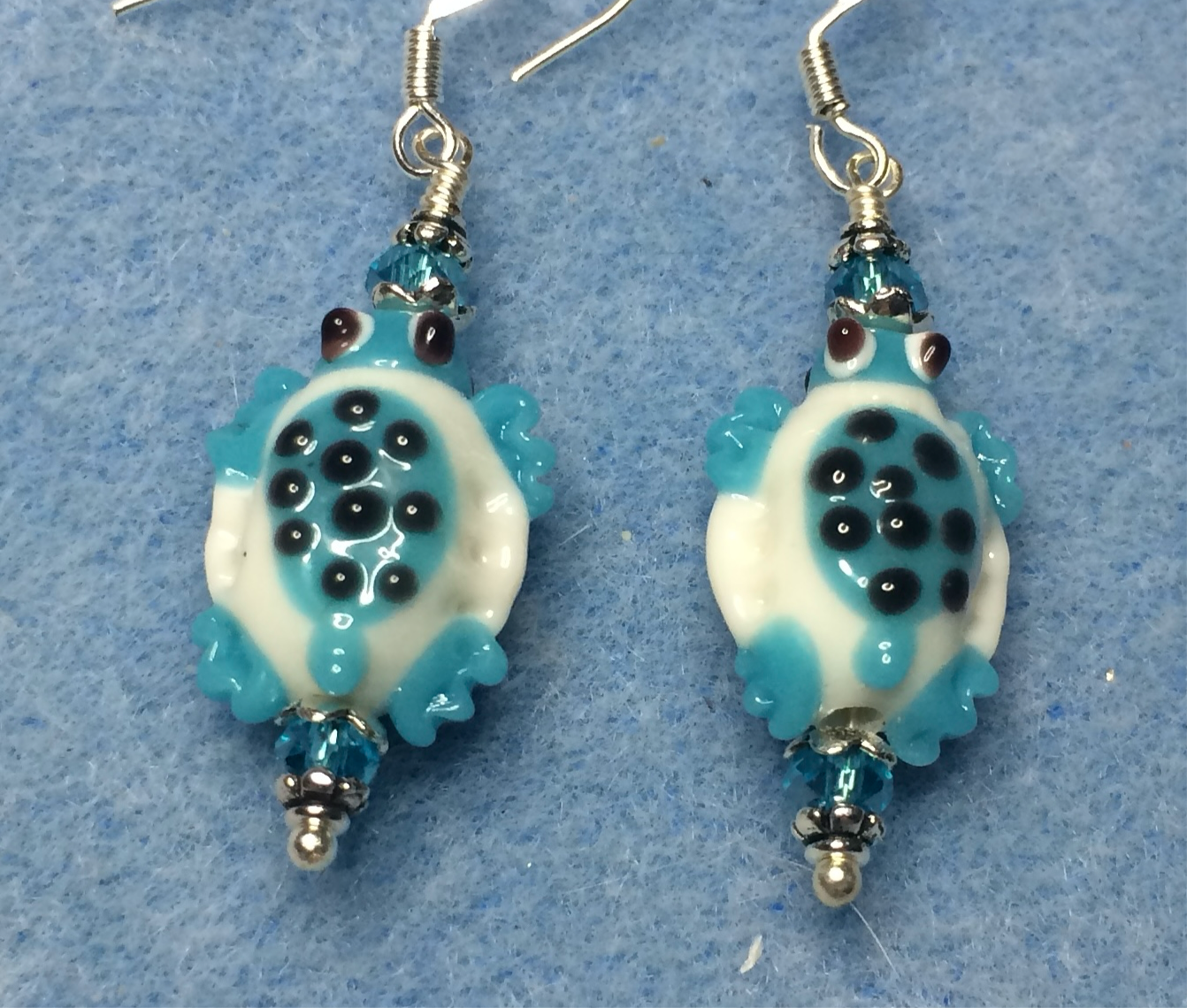 Turquoise and white lamp work spotted turtle bead earrings adorned with turquoise Chinese crystal beads.