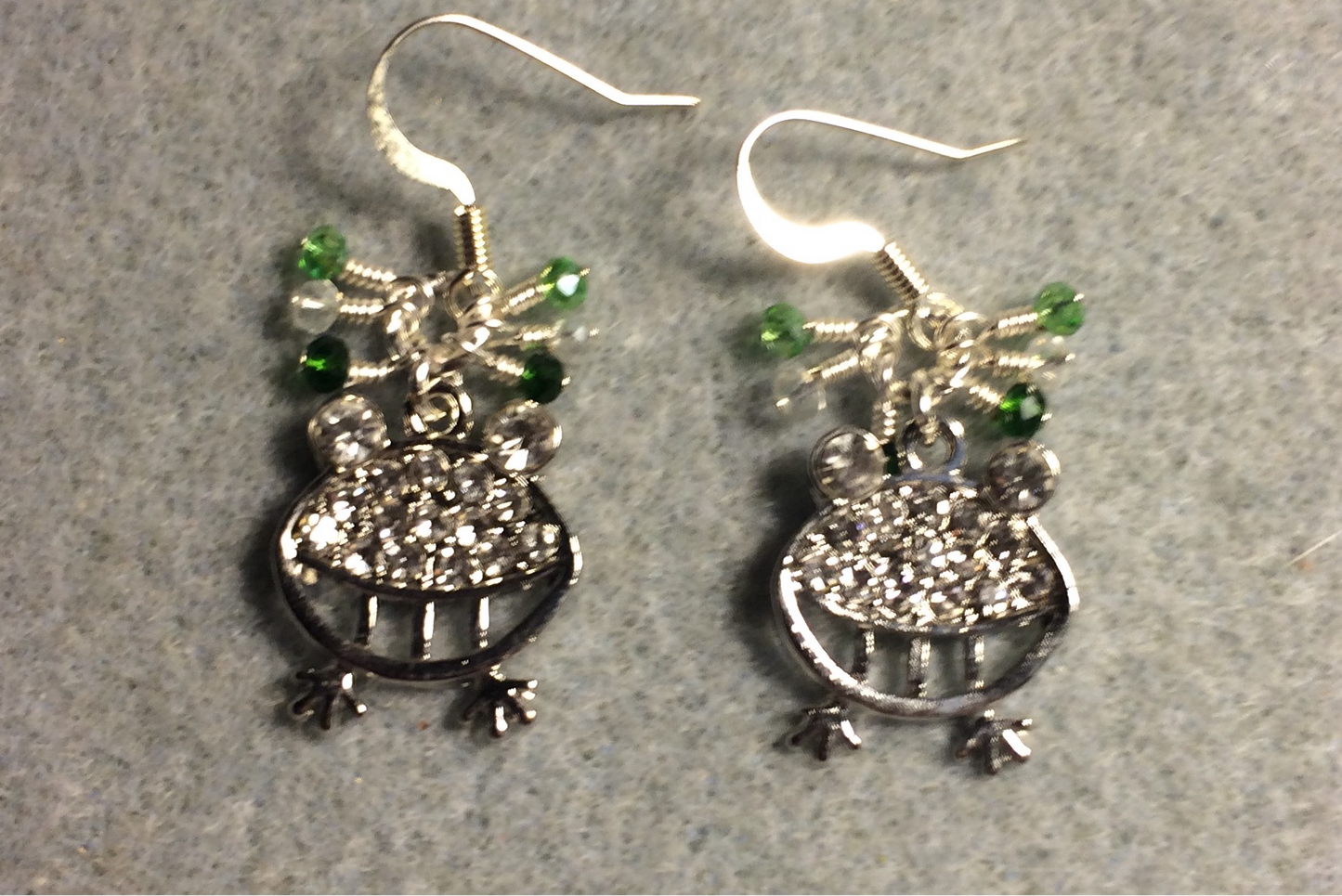 Silver and clear rhinestone silly frog charm earrings adorned with tiny dangling green and clear Chinese crystal beads.