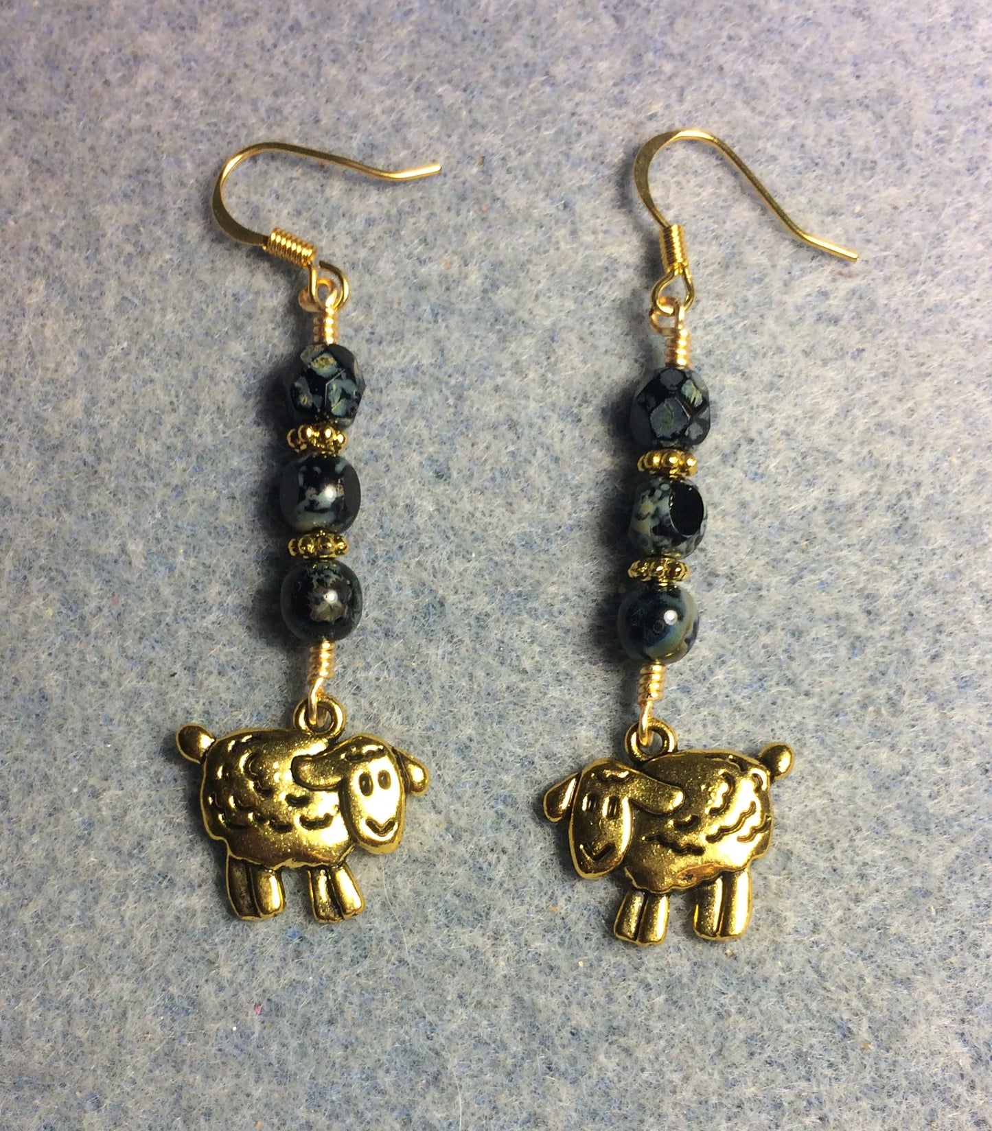 Gold sheep charm earrings adorned with black Picasso Czech glass beads