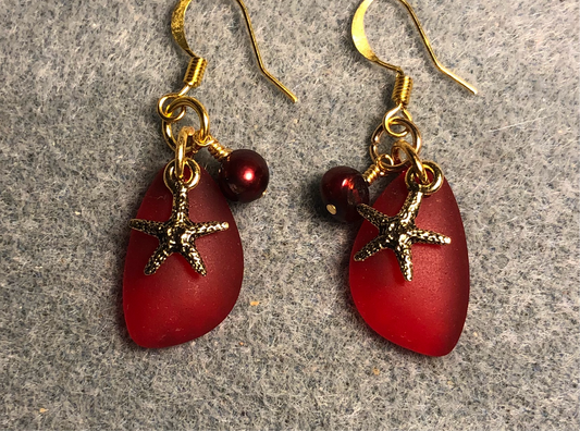 Small red sea glass pendant bead earrings adorned with small gold starfish charms and small red pearl beads.