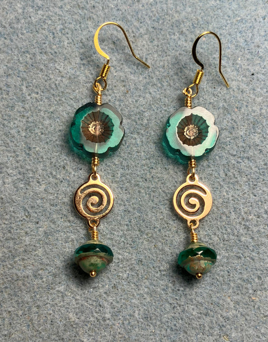 Translucent teal and gold Czech glass pansy bead earrings adorned with gold swirly connectors and teal Czech glass Saturn beads.