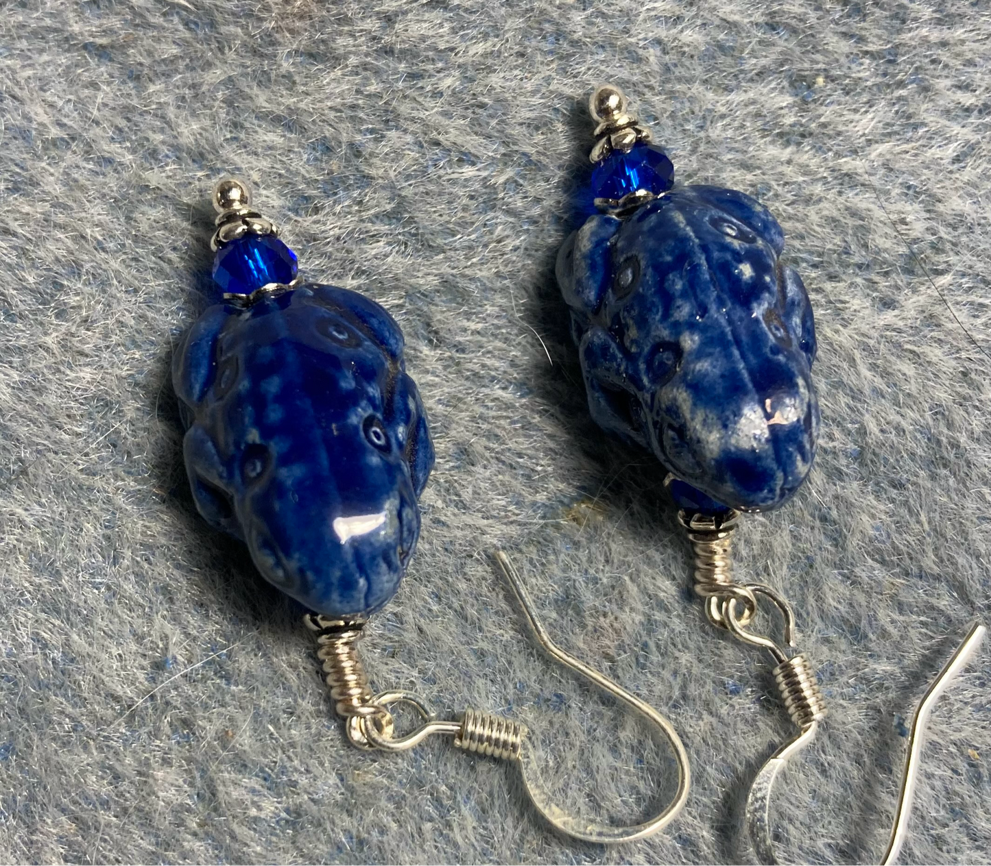 Dark blue ceramic frog bead earrings adorned with dark blue Chinese crystal beads.