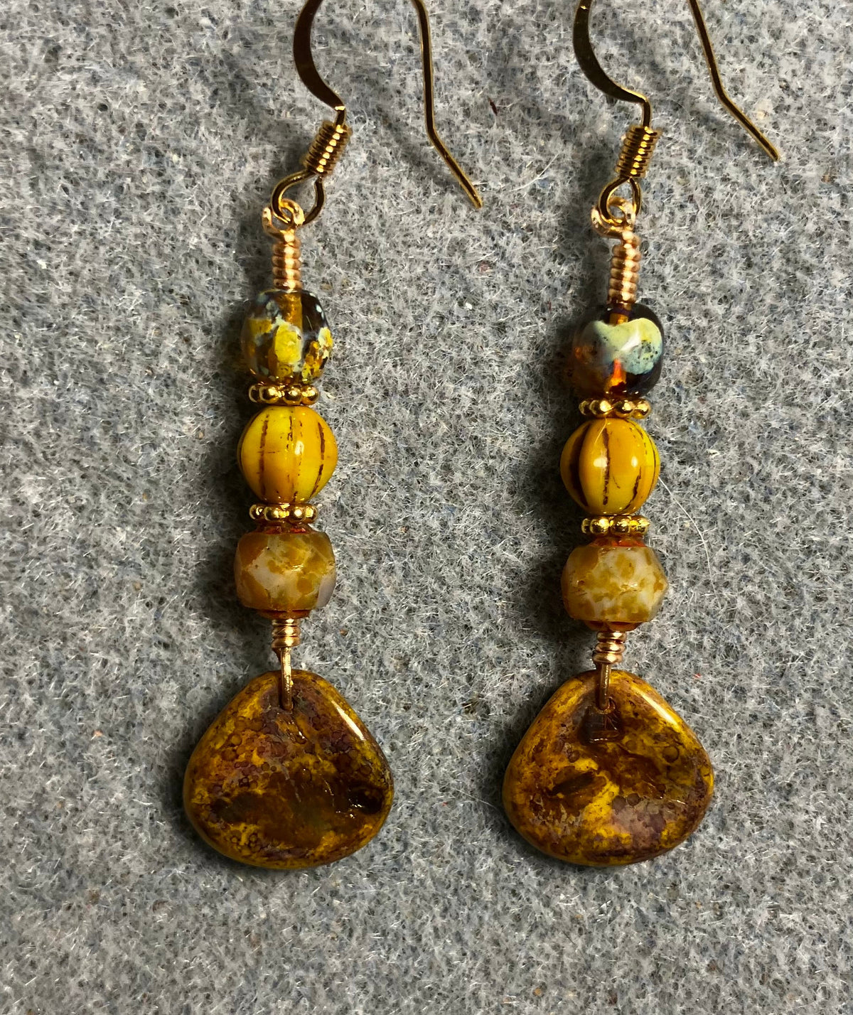 Yellow gold Picasso Czech glass rose petal earrings adorned with yellow Picasso Czech glass beads.