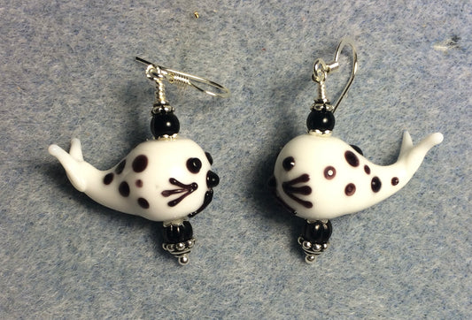 Black and white lamp work spotted whale bead earrings adorned with black Czech glass beads.