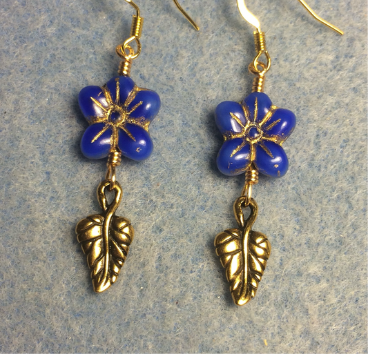 Bright blue (with gold inlay) Czech glass puffy flower bead earrings adorned with gold Tierracast leaf charms.