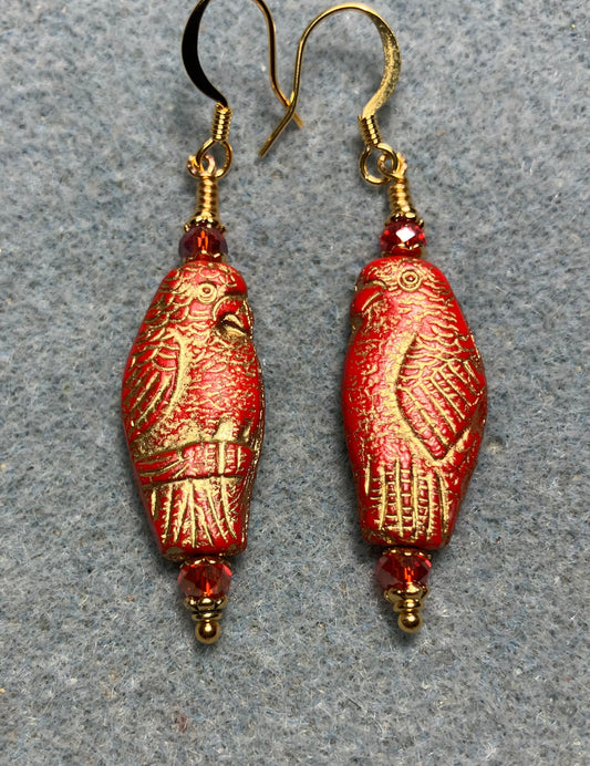 Large red (with gold wash) Czech glass parrot bead earrings adorned with red Chinese crystal beads.