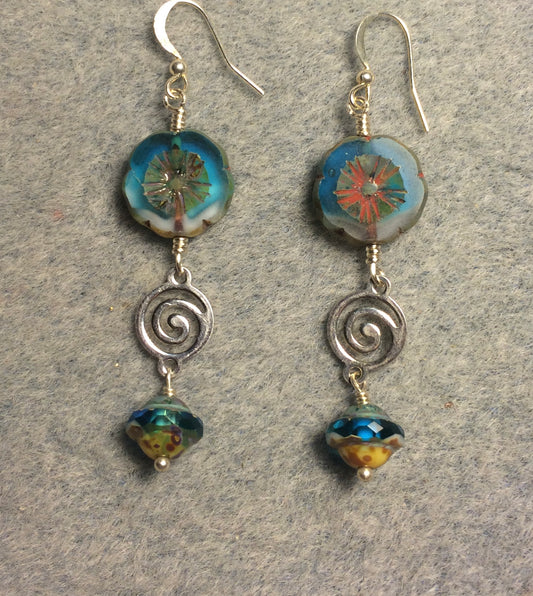 Turquoise and white Czech glass pansy bead earrings adorned with silver swirly connectors and turquoise Czech glass Saturn beads.