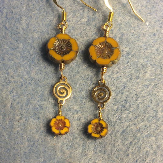 Opaque mustard yellow Czech glass pansy bead earrings adorned with gold swirly connectors and tiny opaque mustard yellow Czech glass pansy beads.