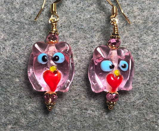 Translucent pink and red lamp work owl bead earrings adorned with pink Chinese crystal beads.