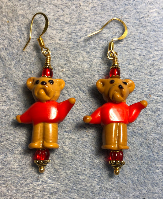 Brown and red lamp work sweater wearing teddy bear bead earrings adorned with red Czech glass beads.