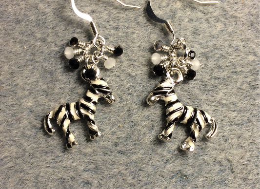 Black and white enamel striped zebra charm earrings adorned with tiny dangling black, white, and silver Chinese crystal beads.