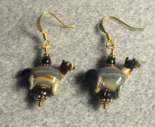 Black, tan, and gray lamp work striped horse bead earrings adorned with black Czech glass beads.