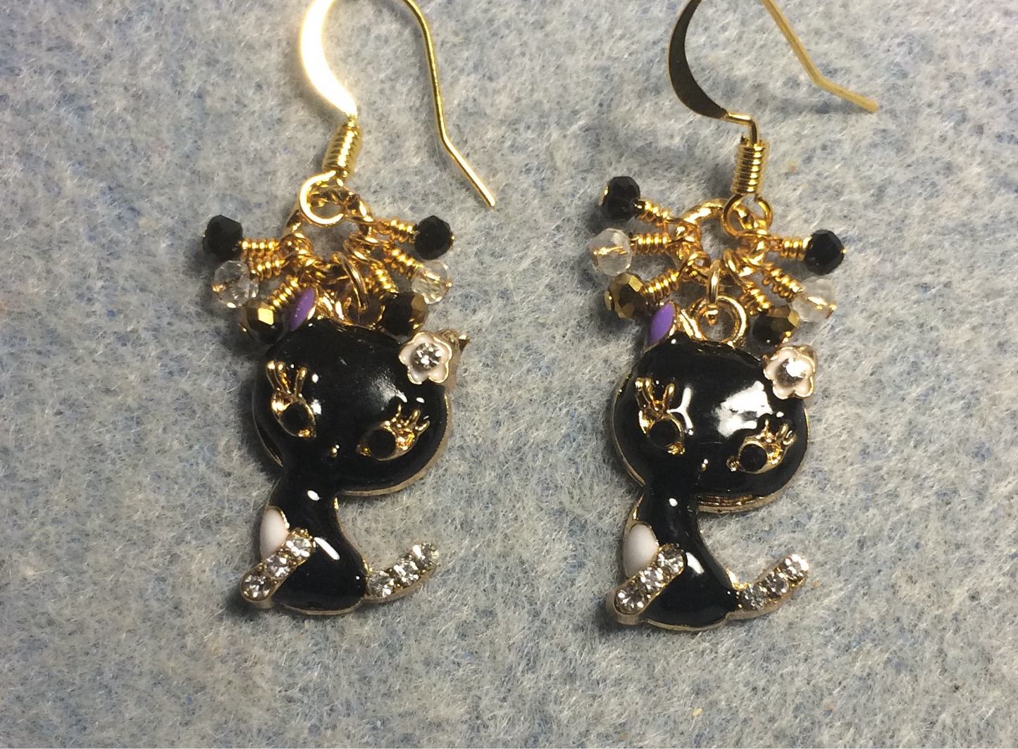 Small black and gold enamel and rhinestone cat charm earrings adorned with tiny dangling black, gold, and clear Chinese crystal beads.