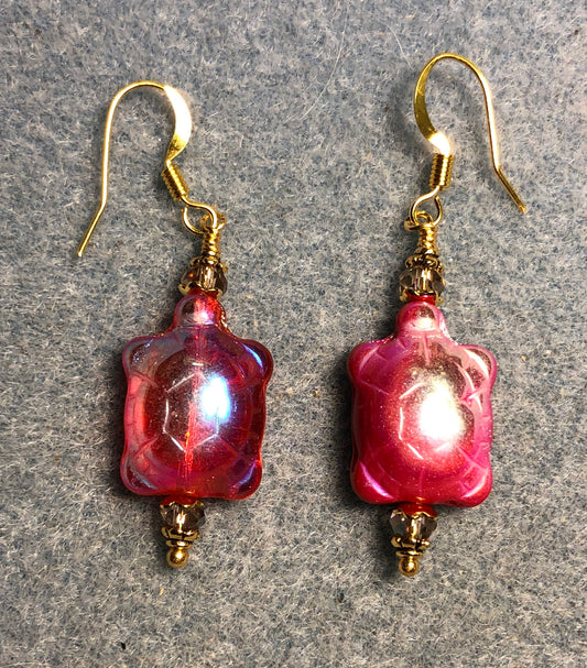 Metallic pinkish red Czech glass turtle bead earrings adorned with sparkly pink Chinese crystal beads.