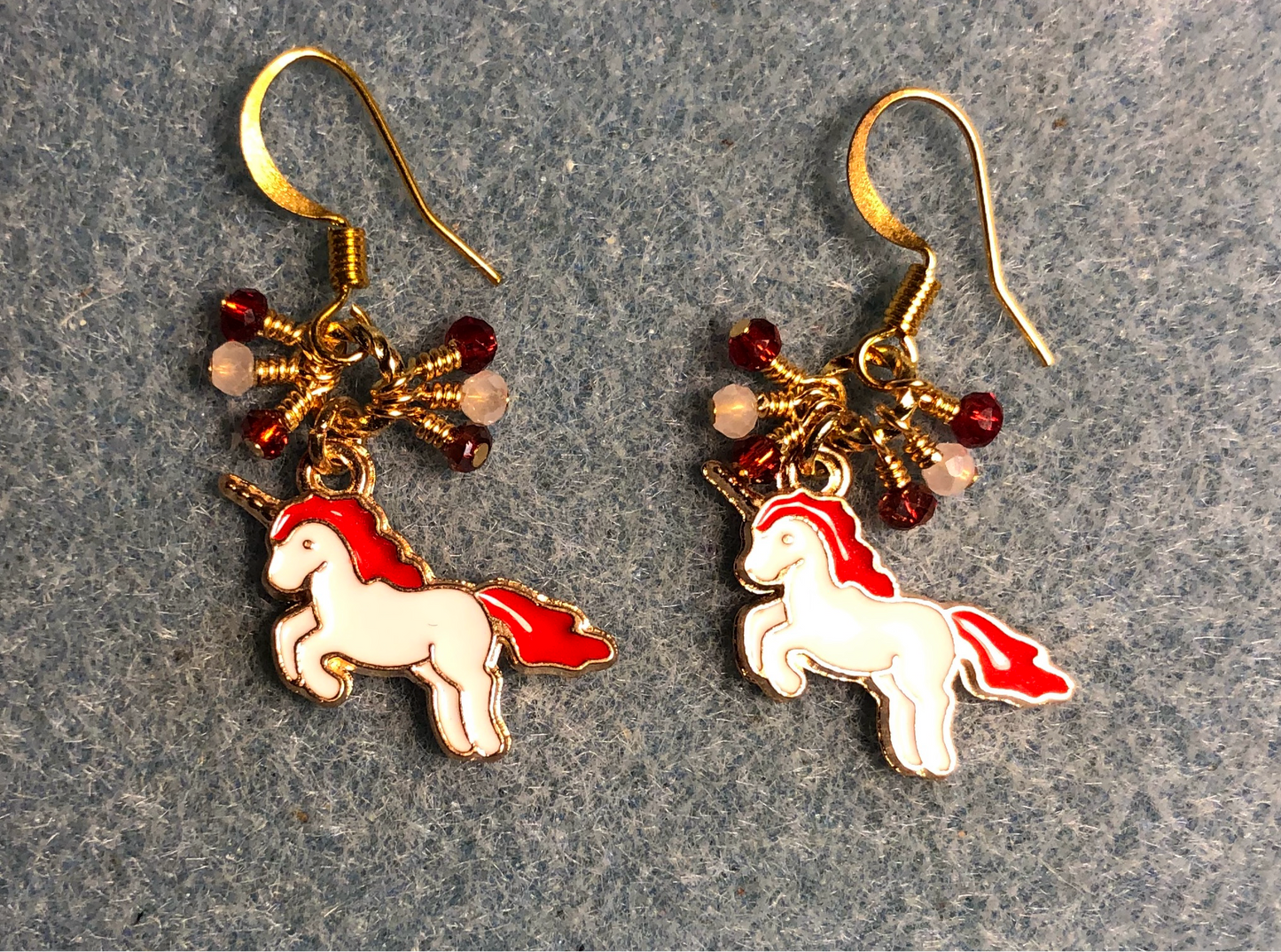 Small red and white enamel unicorn charm earrings adorned with tiny dangling red and white Chinese crystal beads.