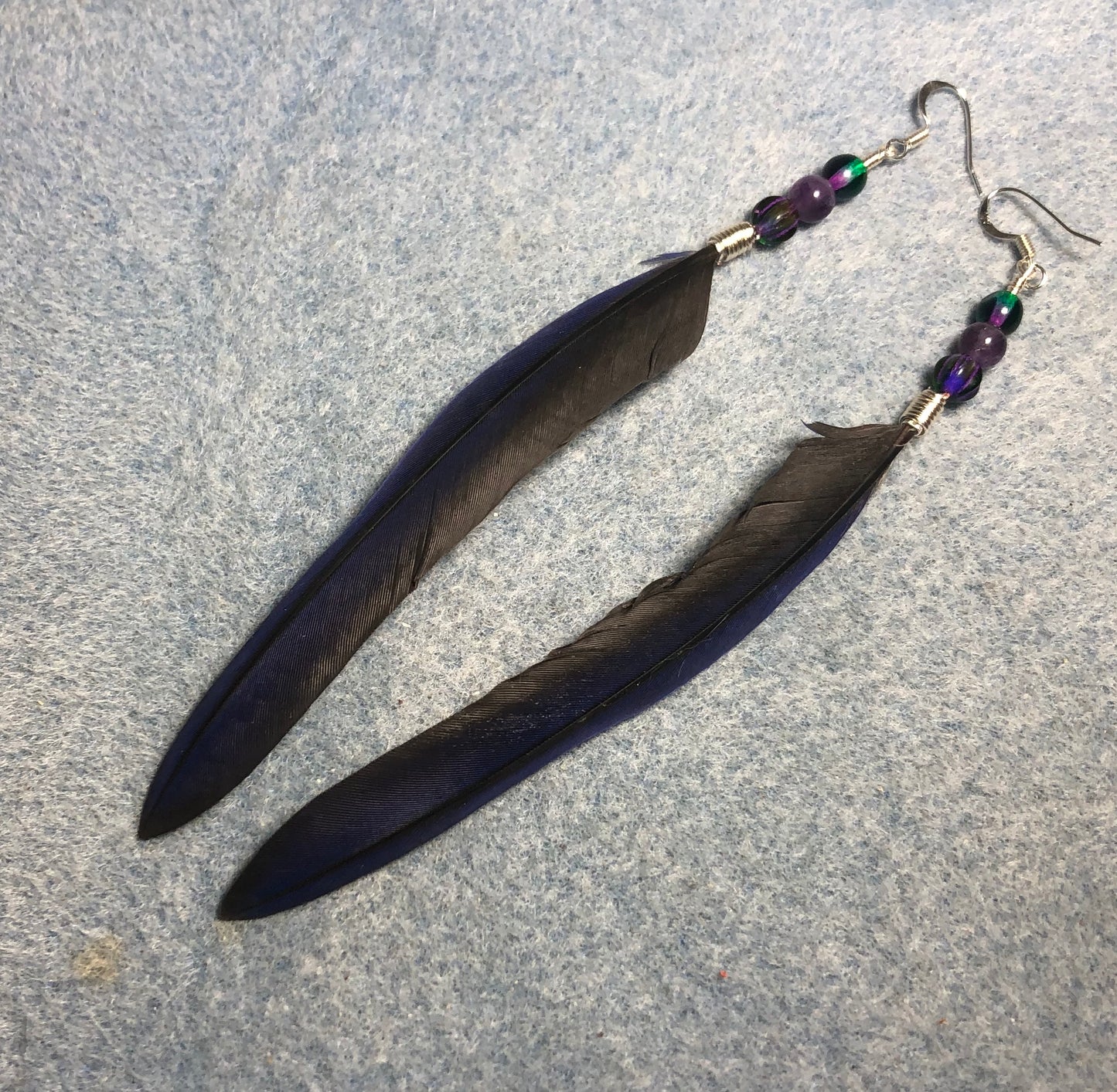 Cobalt blue purple bronze-winged Pionus feather earrings adorned with cobalt blue and purple Czech glass beads.