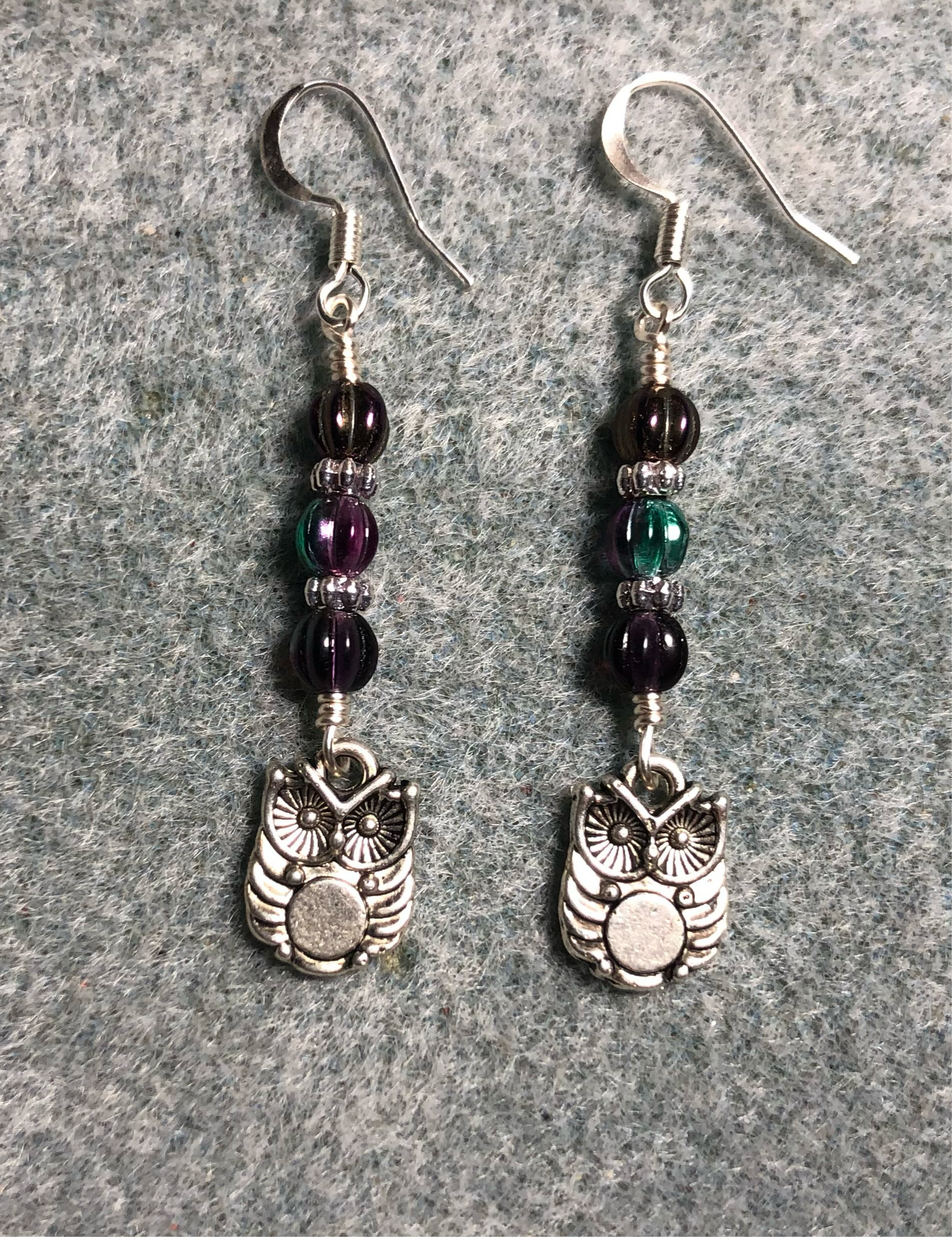 Small silver owl charm earrings adorned with purple Czech glass melon beads.