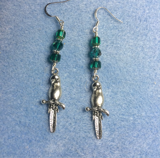 Long silver parrot charm earrings adorned with teal Czech glass beads