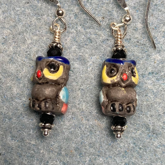 Small dark gray, yellow, and dark blue ceramic owl bead earrings adorned with black Chinese crystal beads.