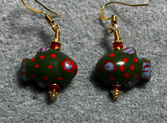 Dark green, red, and blue ceramic spotted fish bead earrings adorned with red Chinese crystal beads.