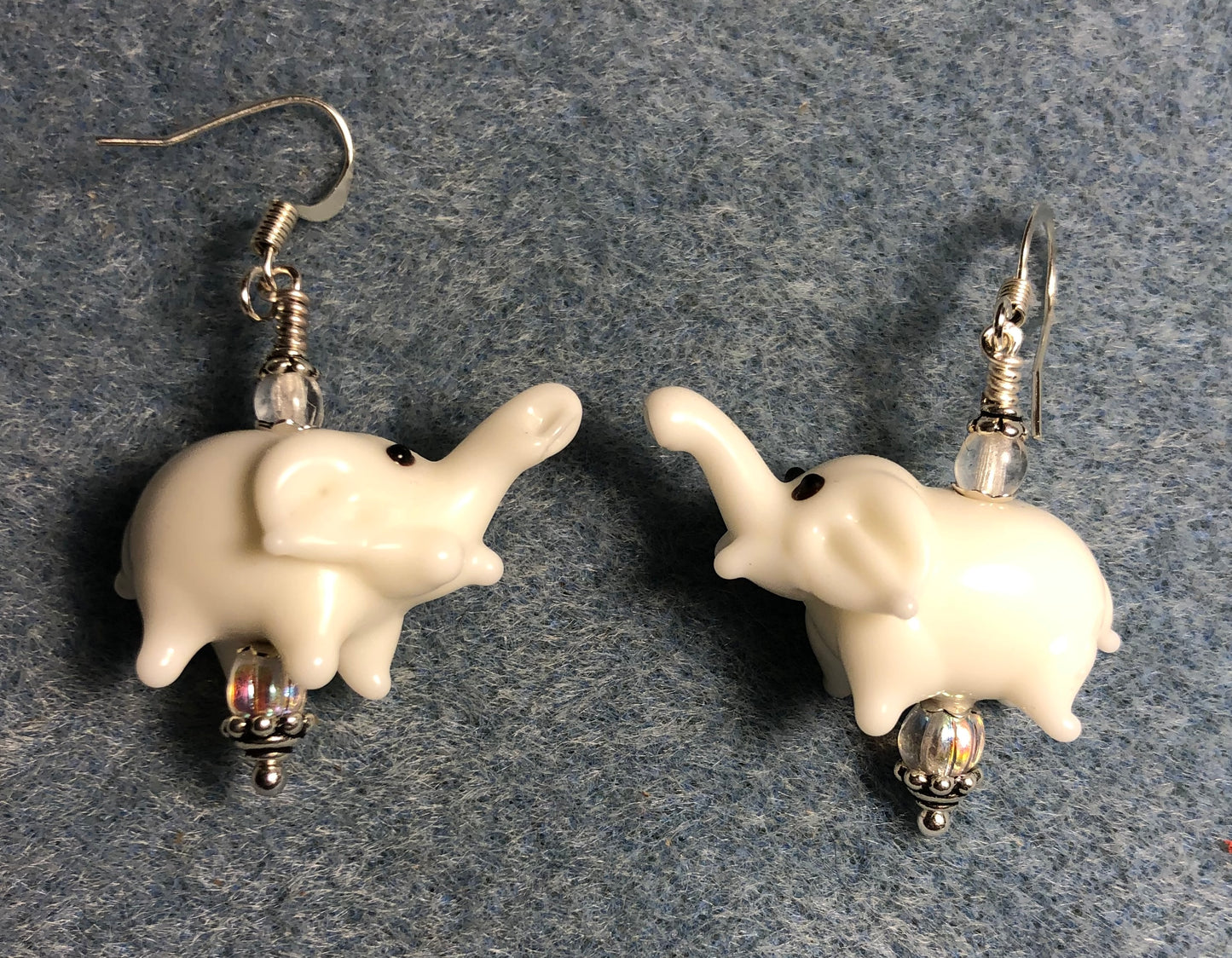 Opaque white lamp work elephant bead earrings adorned with clear Czech glass beads.