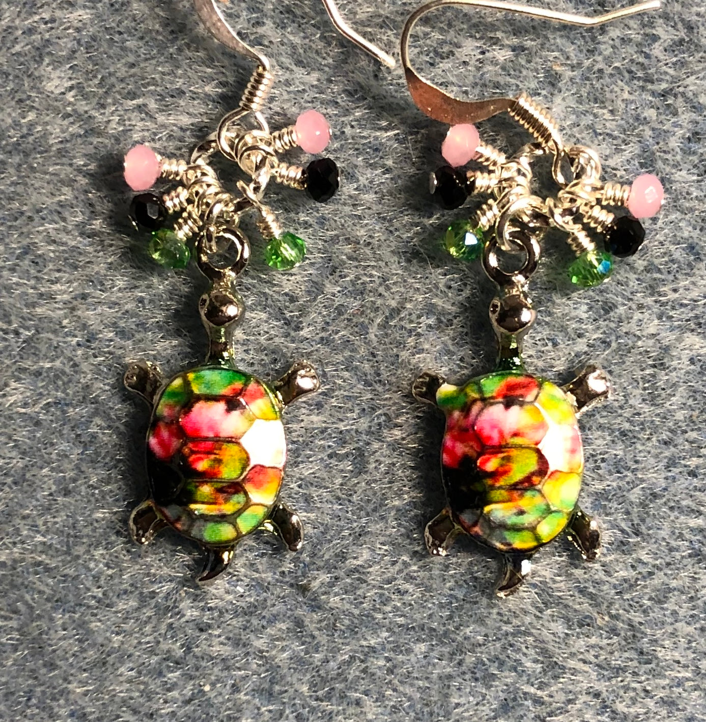 Green, black, and pink enamel turtle charm earrings adorned with tiny dangling green, black, and pink Chinese crystal beads.