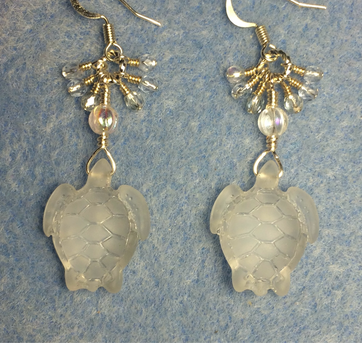 Clear sea glass sea turtle bead earrings adorned with clear Czech glass beads and small dangling clear Czech glass beads.