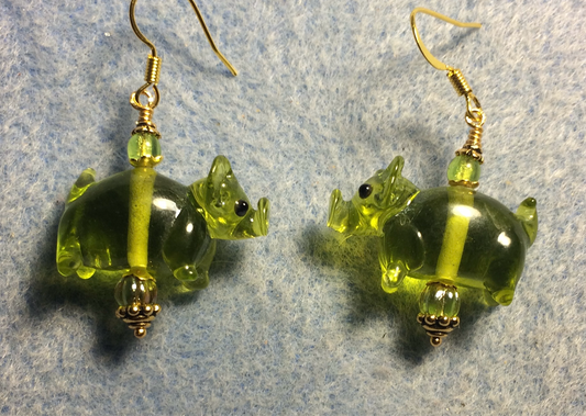 Translucent olive green lamp work pig bead earrings adorned with olive green Czech glass beads.
