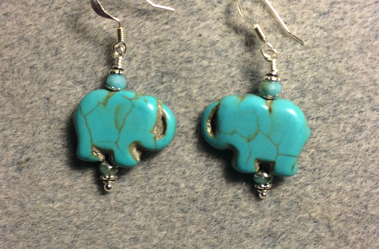 Turquoise howlite gemstone elephant bead earrings adorned with turquoise Chinese crystal beads.