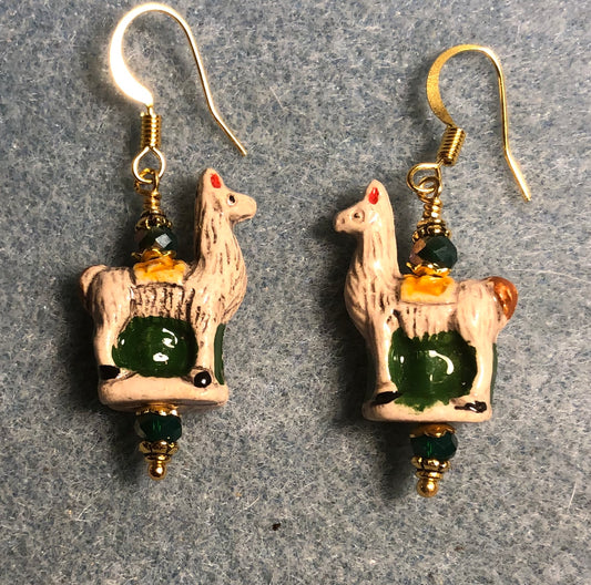 Small tan, dark green, and yellow ceramic llama bead earrings adorned with dark green Chinese crystal beads.