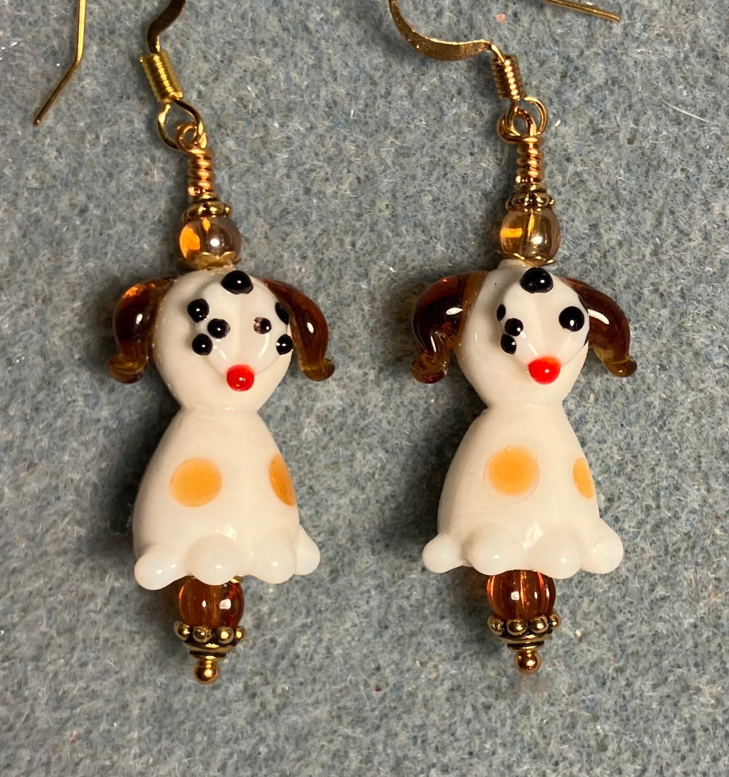 White and caramel lamp work puppy dog bead earrings adorned with caramel Czech glass beads.
