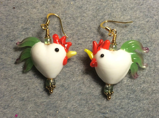White with green tails heart shaped lamp work rooster bead earrings adorned with green Czech glass beads.