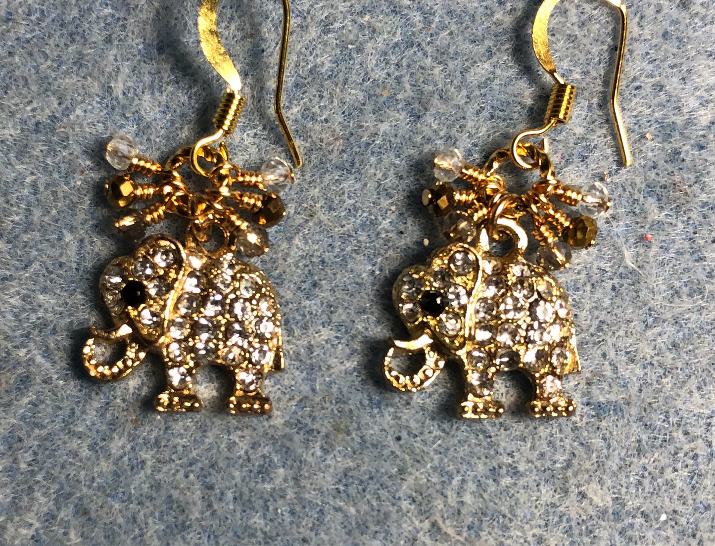 Gold and clear rhinestone elephant charm earrings adorned with tiny dangling amber, clear, and gold Chinese crystal beads.