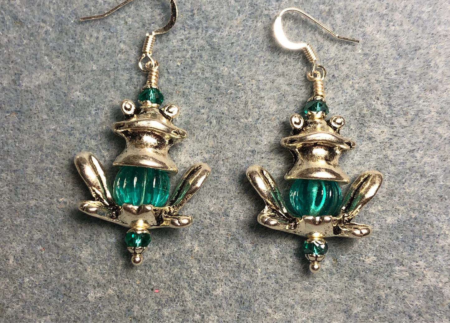 Silver frog bead cap earrings adorned with large teal Czech glass beads.