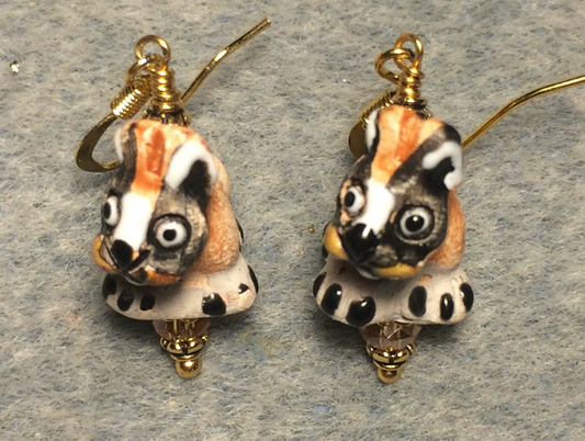 Small black, gray, and tan ceramic dog bead earrings adorned with gray Chinese crystal beads.