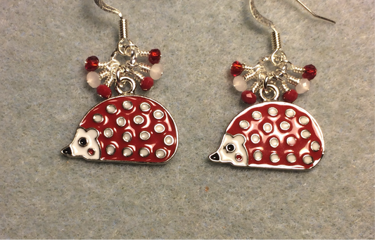 Red and white enamel spotted porcupine charm earrings adorned with tiny dangling red and white Chinese crystal beads.